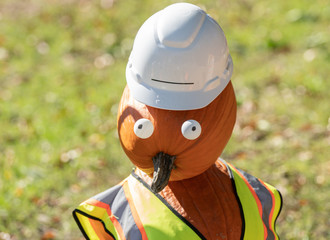 jack o lantern construction worker poses for you
