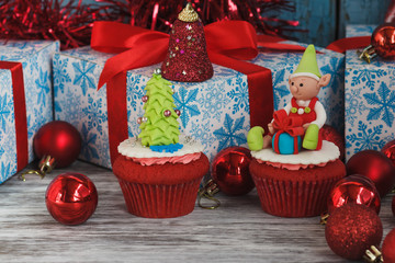 Christmas cupcakes with colored decorations, soft focus background