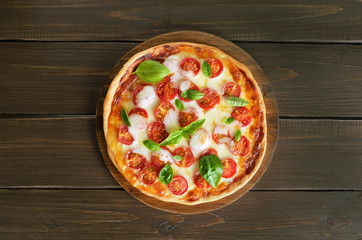 Pizza Margarita on wooden cutting board