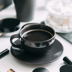 Coffee with a in the black a Cup. Layout Flatley in the workplace. Stylish blogger set.