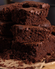 Home baked chocolate brownies on brown paper