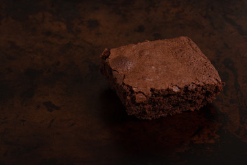 Slices of chocolate brownie on dark tin