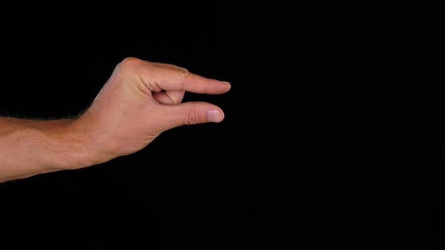 Close up forefinger and thumb finger showing something small on black background