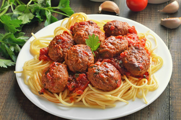Meatballs with tomato sauce and spaghetti on plate