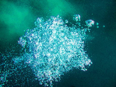 Air boobles in blue sea water.