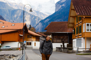 A man turist looking for a shalet in the Swiss Alps
