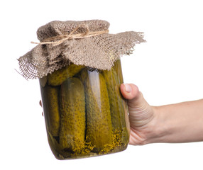 Bank of canned cucumbers in hand on a white background. Isolation