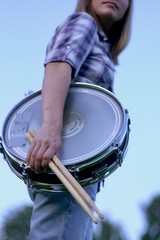 Girl holding snare drum and sticks