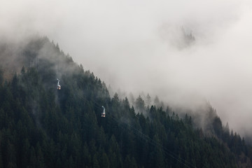 Row of cablecars against cloudy sky in the Swiss Alps