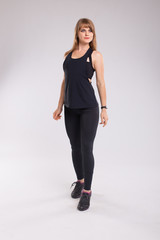 Full-length portrait of a young cheerful woman standing on isolated on white background