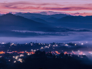 Misty mountains and village landscape in the morning