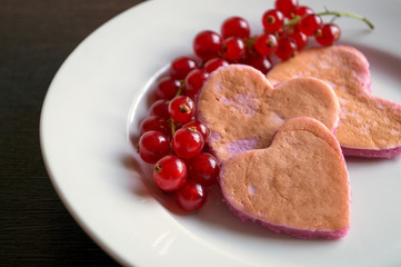 Berry homemade pancakes on a black background.