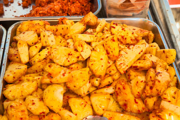 Pineapple with hot chilli peppers on a street market . Sri Lanka.