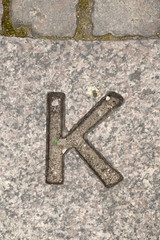 Letter K. On stone background