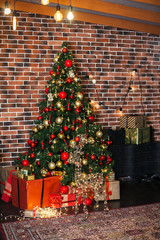 Beautiful Christmas living room with decorated Christmas tree, gifts and deer with the glowing lights at night. New Year loft interior with New year tree with red and gold decor balls