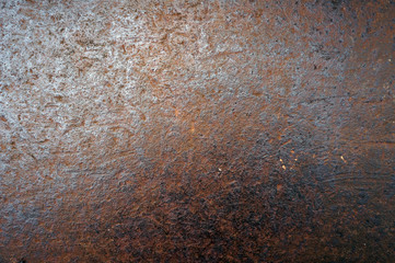 Rusty metal surface.  Brown background.