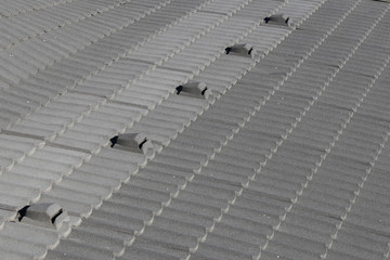 The roof is covered with black synthetic tiles