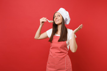 Housewife female chef cook or baker in striped apron, white t-shirt, toque chefs hat isolated on red wall background. Housekeeper woman hold tasting with soup ladle dipper. Mock up copy space concept.