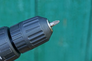 black screwdriver cartridge with bit on a green background