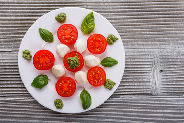 Caprese salad on a wooden rustic background