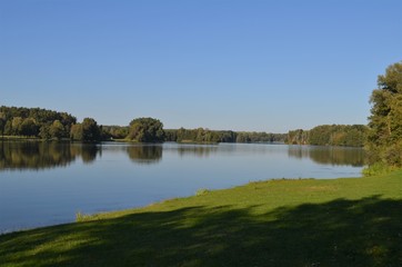 Fototapeta na wymiar Rothsee in Germany, big lake in the nature with green shore and trees, forest