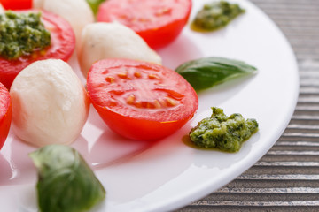 Caprese salad on a wooden rustic background
