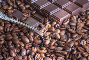 Dark chocolate bars with coffee beans closeup