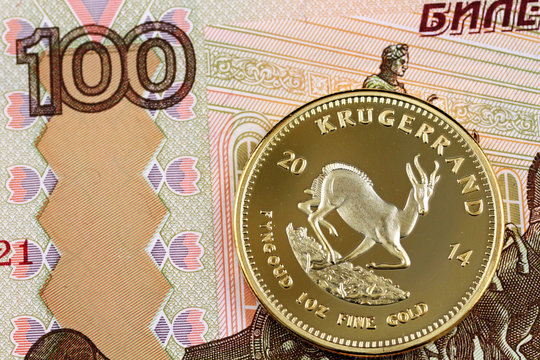 A hundred Russian ruble bank note and a gold South African one ounce coin