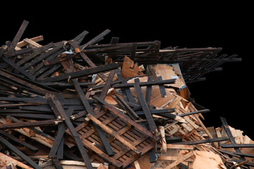 Pile of discarded wood scraps on a black background