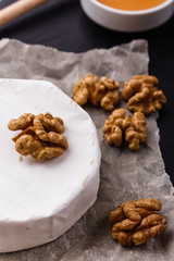 delicious creamy camembert cheese on a wooden rustic background