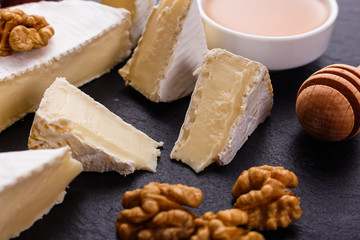 delicious creamy camembert cheese on a wooden rustic background