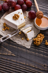 delicious creamy camembert cheese on a wooden rustic background