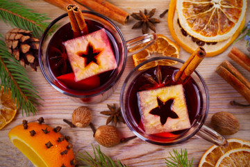 Mulled wine hot drink with spices, citrus fruits and apples. Seasonal and holidays concept. overhead, top view