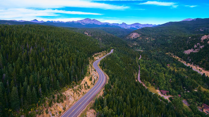 Fototapeta na wymiar Open Road Pine Trees in Rocky Mountains