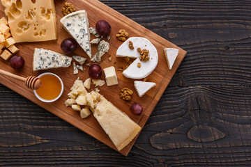 set of different cheeses on a wooden rustic background