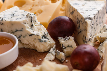 set of different cheeses on a wooden rustic background