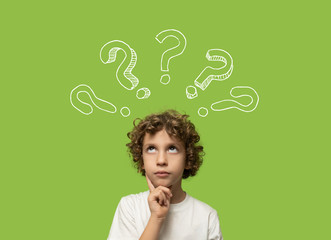 thinking kid - 6 years old child thinking and asking himself a question. Elementary school boy...