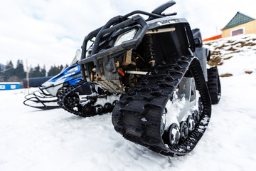 Two snowmobiles in the mountains at ski resort