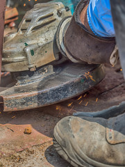 locksmith cuts the gate with a diax grinder
