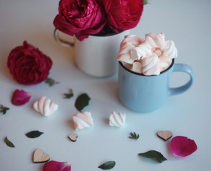 a mug of coffee with marshmallows,wooden heart and pink roses/love/ valentines/birthday background with copy space