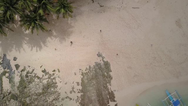 Aerial pedestal up looking directly down on beautiful sandy Guyam Island, Siargao, the Philippines