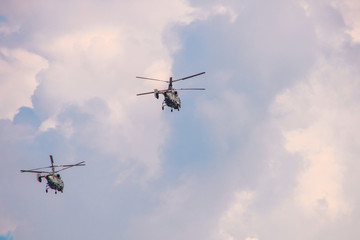 Fototapeta na wymiar Helicopters with two propellers in a cloudy sky