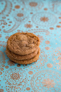 Stacked ginger cookies on holiday paper