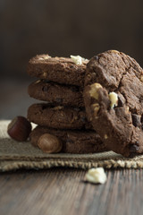 Soft dark chocolate brownie cookies on wood