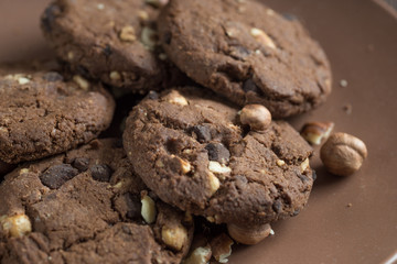 Soft dark chocolate brownie cookies on wood