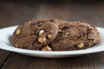 Soft dark chocolate brownie cookies on wood