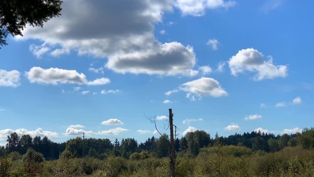 Blue Sky with Clouds and Small Hellicopter in Distance