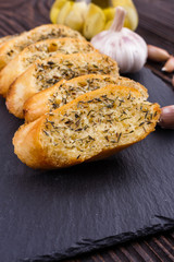 fragrant garlic bread on a dark stone plate