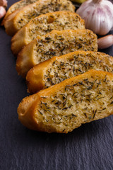 fragrant garlic bread on a dark stone plate