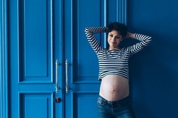 A young girl in anticipation of a child. Stylish studio photo